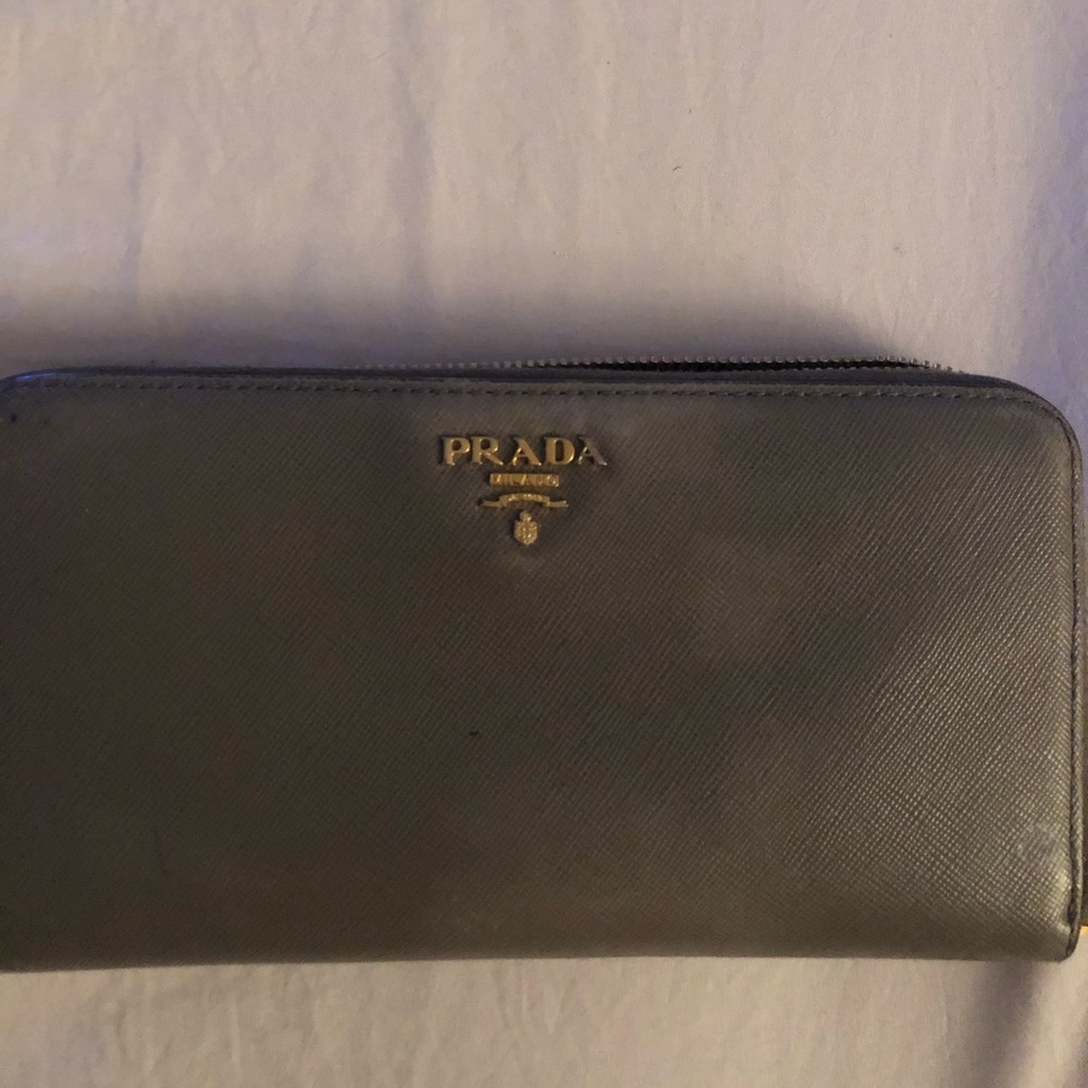 Gray Prada zipper wallet.